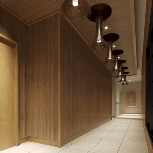 A modern hallway features wooden walls, ceiling lights, and tiled flooring, leading to a brightly lit space at the end of the corridor.