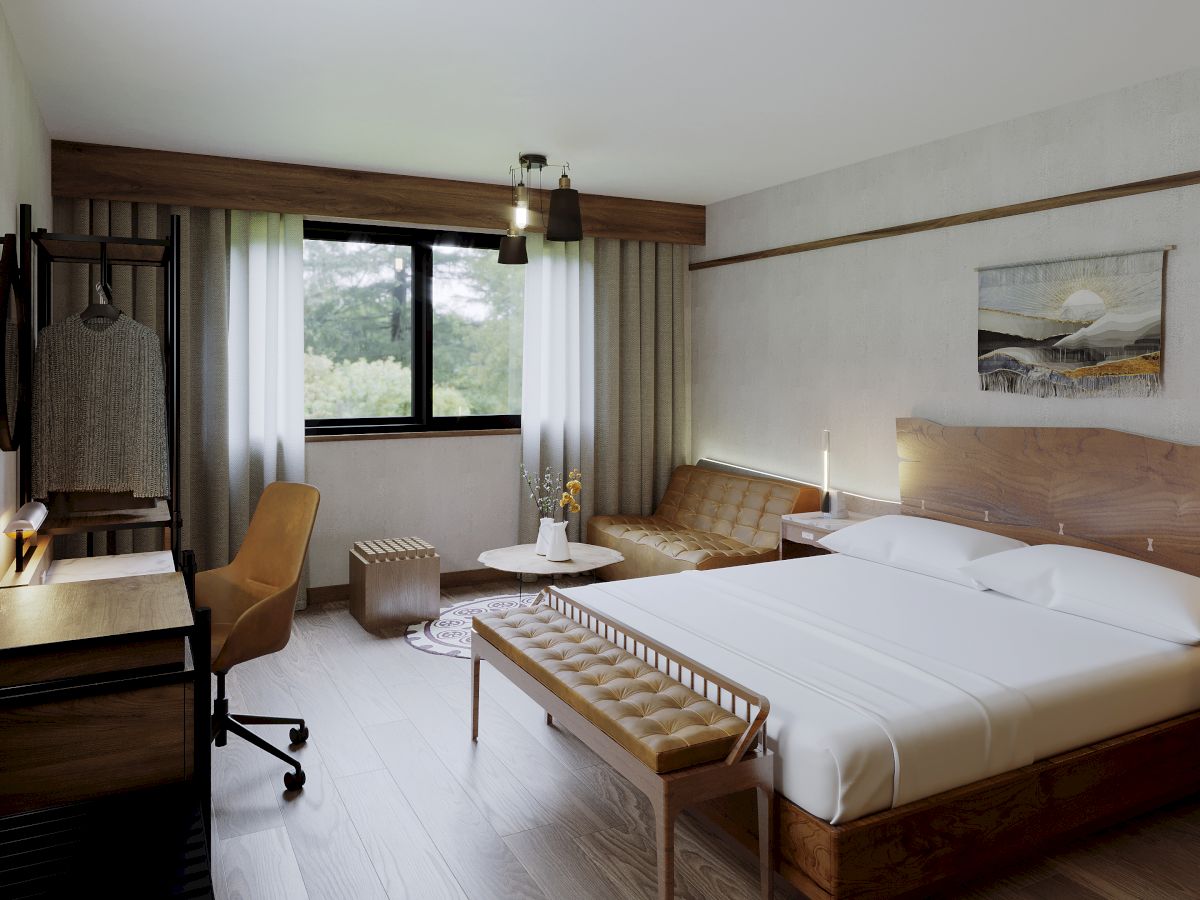 A modern hotel room with a double bed, desk, chair, bench, and sofa; window with a view of trees, minimalistic decor, and earthy tones.